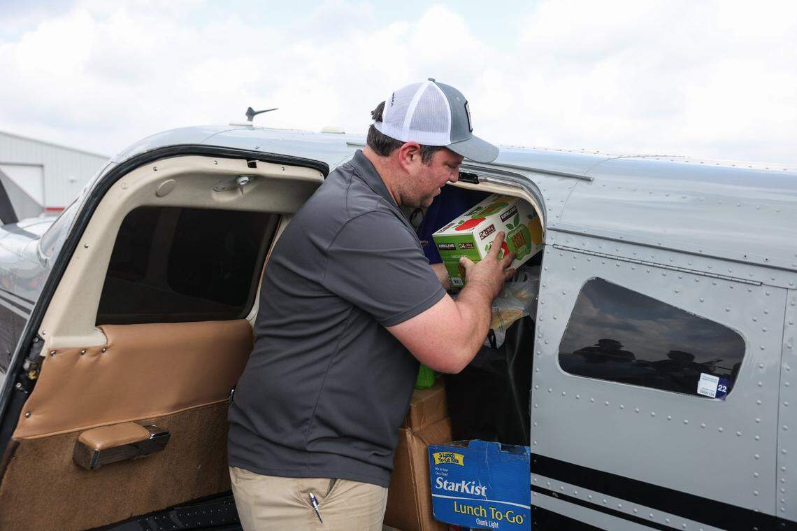David Asman helps load several hundred pounds of supplies into a piper lance airplane that he will fly into Ashe County, which sustained catastrophic flooding over the weekend, in Concord, NC on Monday, September 30, 2024.