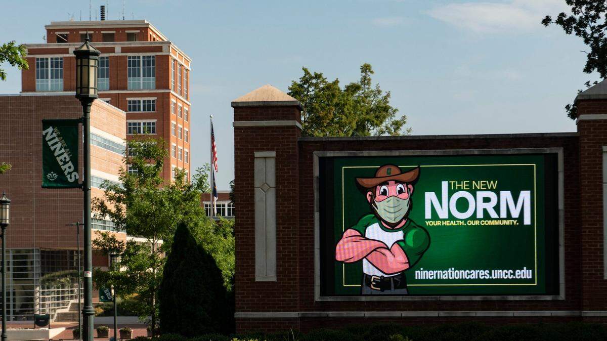 A sign depicting the school’s mascot wearing a mask is seen on the campus of UNC-Charlotte on Monday, July 20, 2020.