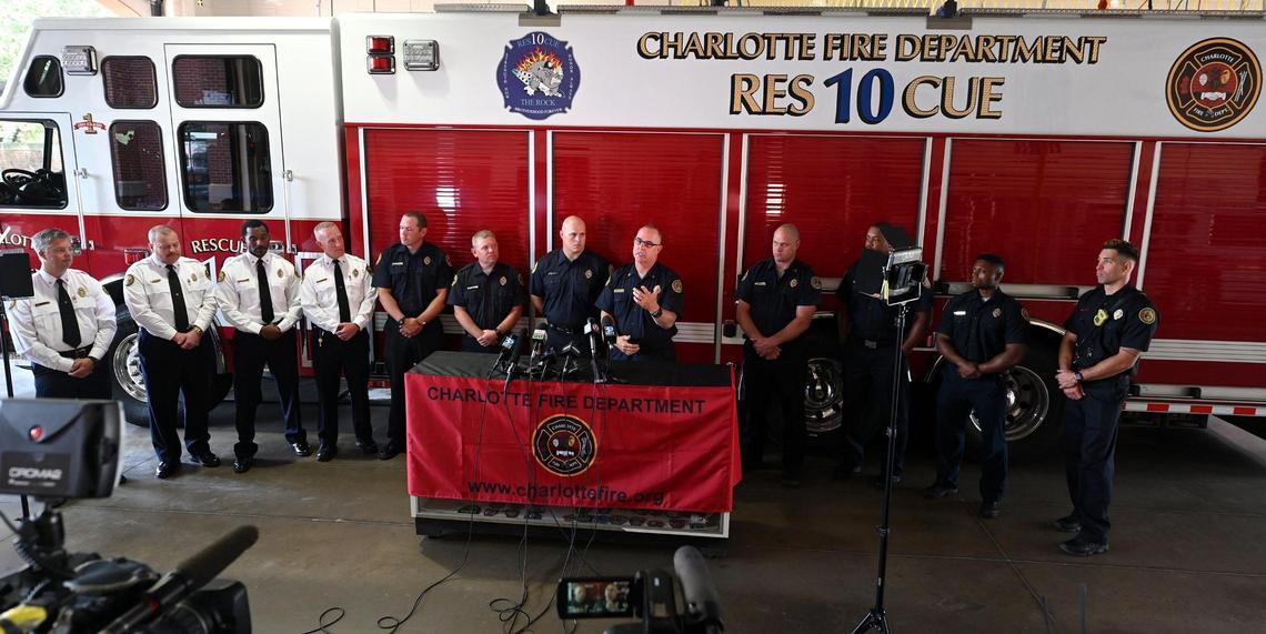 Charlotte Station 10 Capt. Jeff Bright, center, speaks during a press conference detailing the five-alarm fire in SouthPark on May 18.