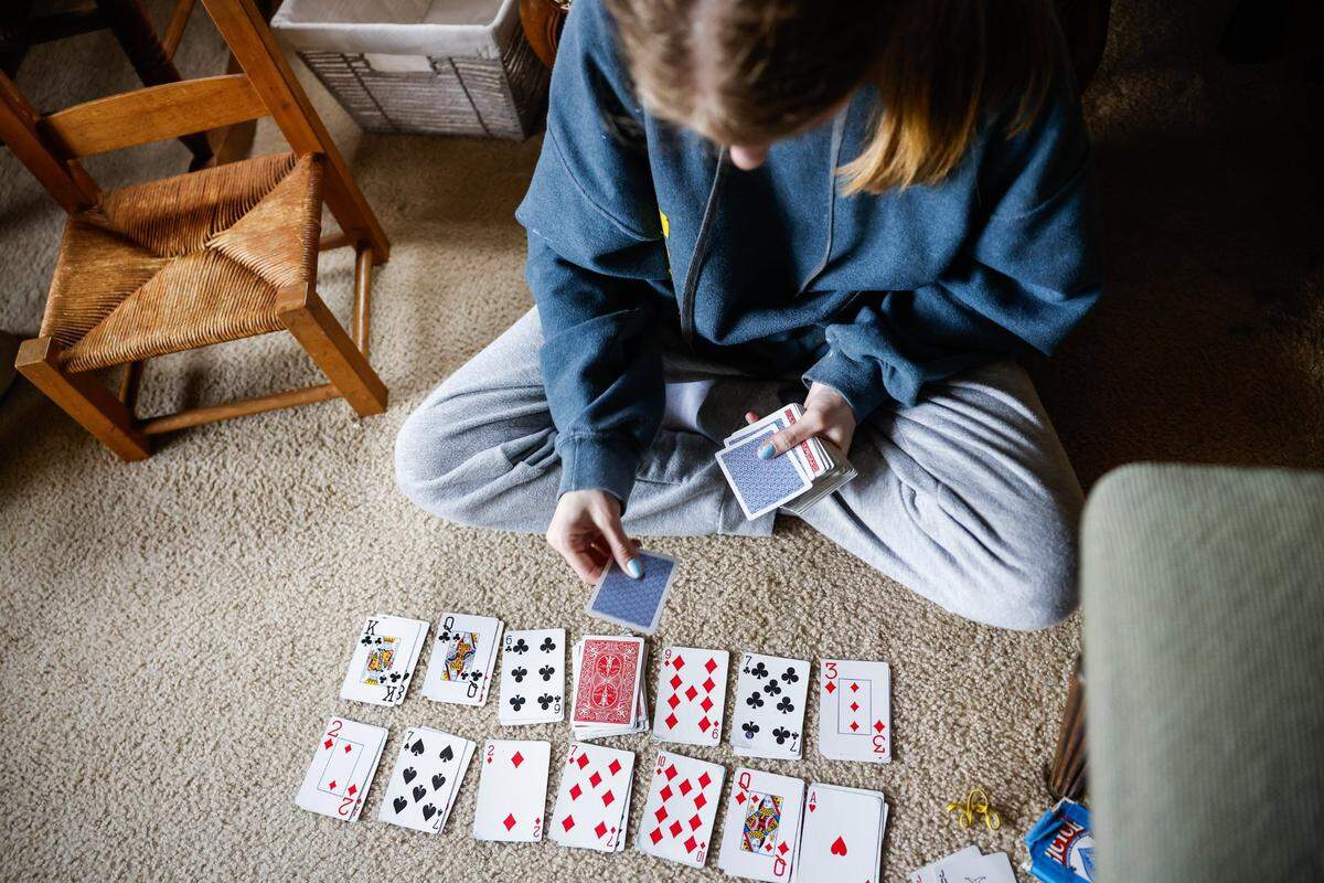 Margaret Van Bruggen, recovering from a heart valve transplant last November, learned to play solitaire at home in Charlotte. Margaret, 14, became the first recipient of a living mitral valve replacement. She received the valve from 11-year-old Journi Kelly, who donated another to 9-year-old Kensley Frizzell. Duke pioneered the partial heart transplant in 2022.