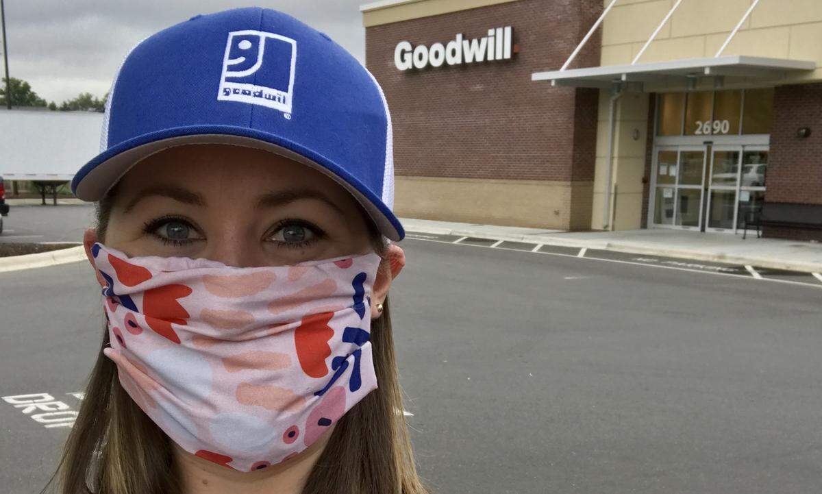 Samantha Story is wearing a colorful mask from her coworker at Goodwill Industries of the Southern Piedmont.