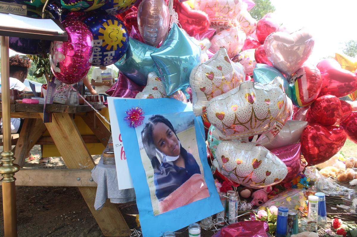 Family, friends and many others turned a picnic table into a memorial for Loyalti Allah, a 13-year-old who was fatally shot in a drive-by shooting on Icemorelee Street in Monroe, NC, on Saturday, July 24, 2021.