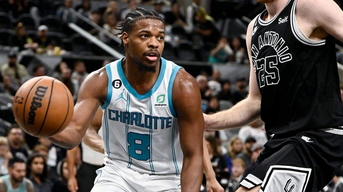 Charlotte Hornets’ Dennis Smith Jr. (8) drives against San Antonio Spurs’ Jakob Poeltl during the first half of an NBA basketball game, Wednesday, Oct. 19, 2022, in San Antonio. Charlotte won 129-102. (AP Photo/Darren Abate)