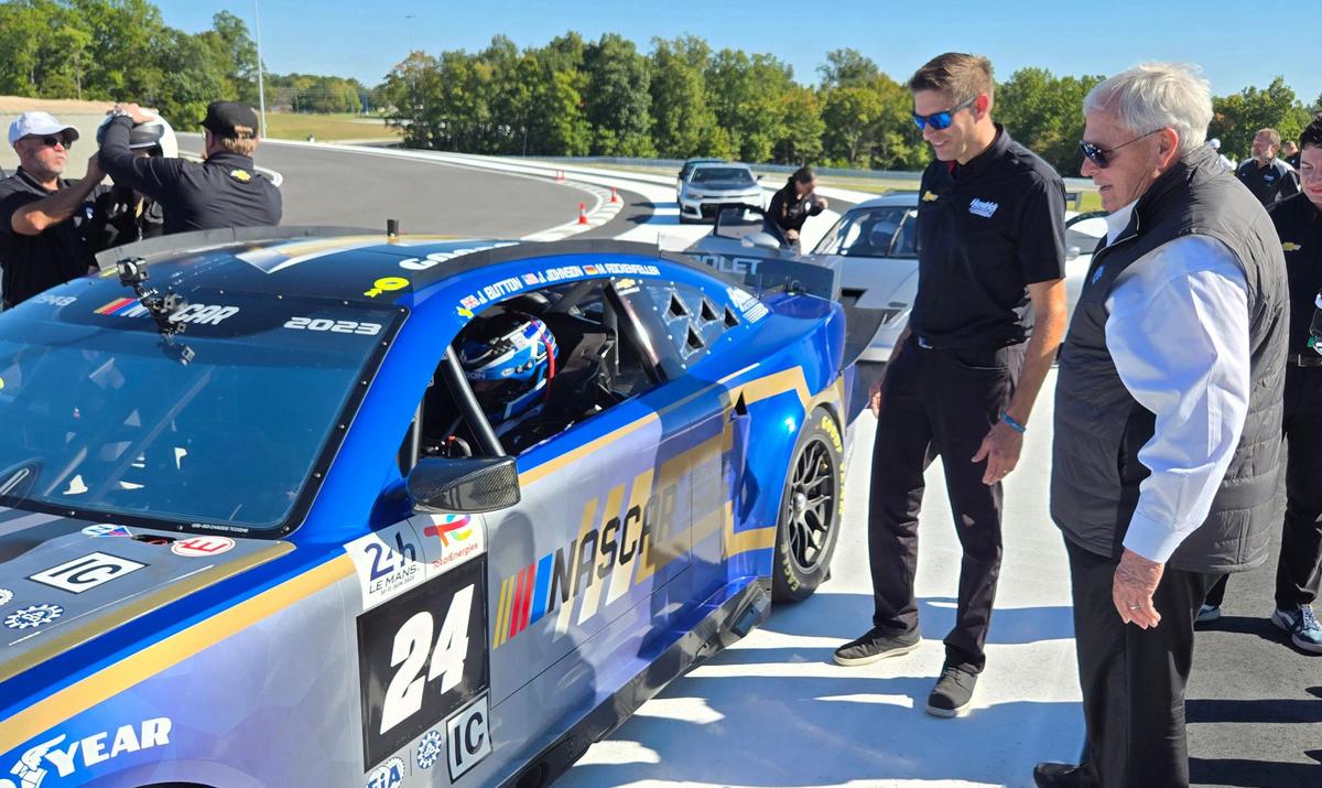 Rick Hendrick, owner of Hendrick Motorsports, at right, spends time with drivers and visitors during the announcement for the new Ten Tenths Motor Club.