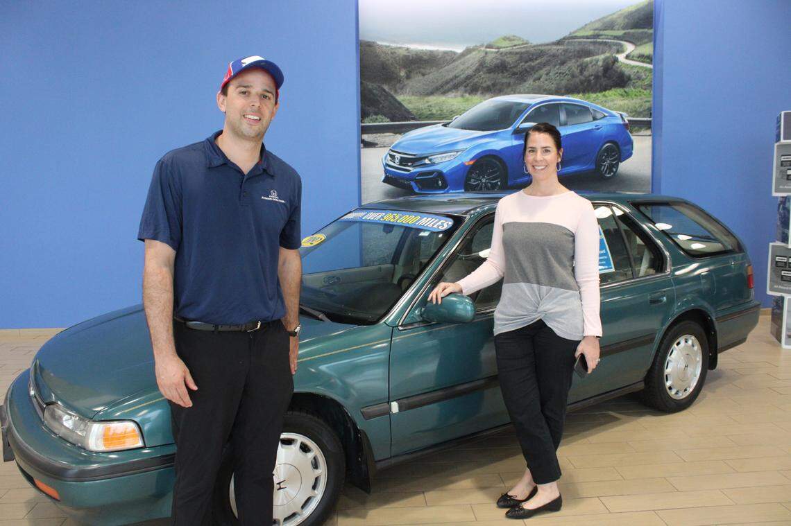 Lauren Salinas Layne and David Salinas of McKenney-Salinas Honda have a 1992 Honda Accord EX wagon with nearly a million miles on it on display at the dealership in Gastonia, NC.
