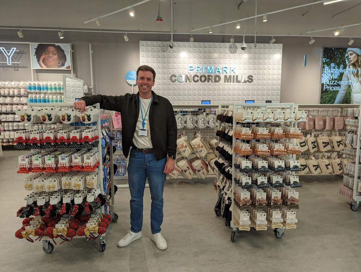 Primark President Kevin Tulip stands near the registers Wednesday near the new store opening at Concord Mills.