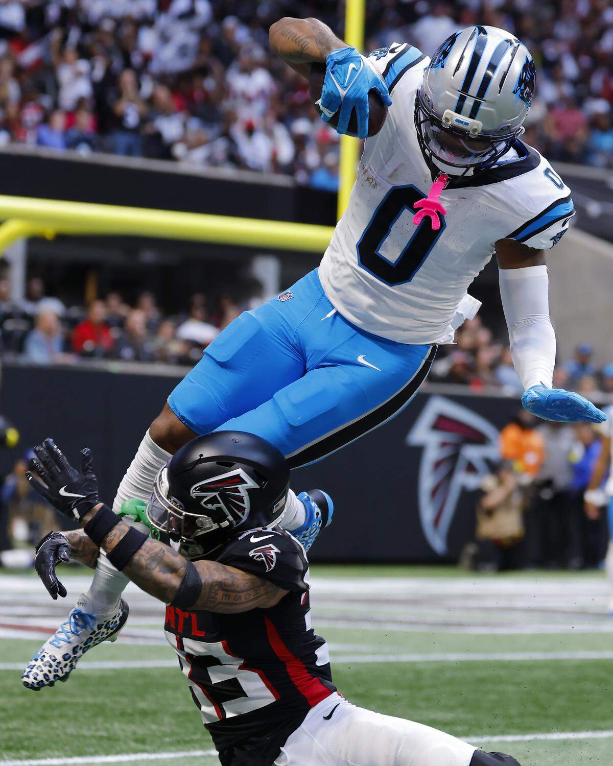 Carolina Panthers TE Ja’Tavion Sanders is tackled by Atlanta Falcons DB Billy Bowman Jr. during Sunday’s second quarter at Mercedes-Benz Stadium in Atlanta.
