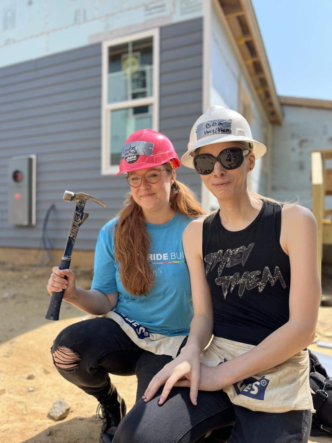 Lindsey Halliday (left) and her partner Bea helped volunteers build their first home for this year’s Pride build in Raleigh.