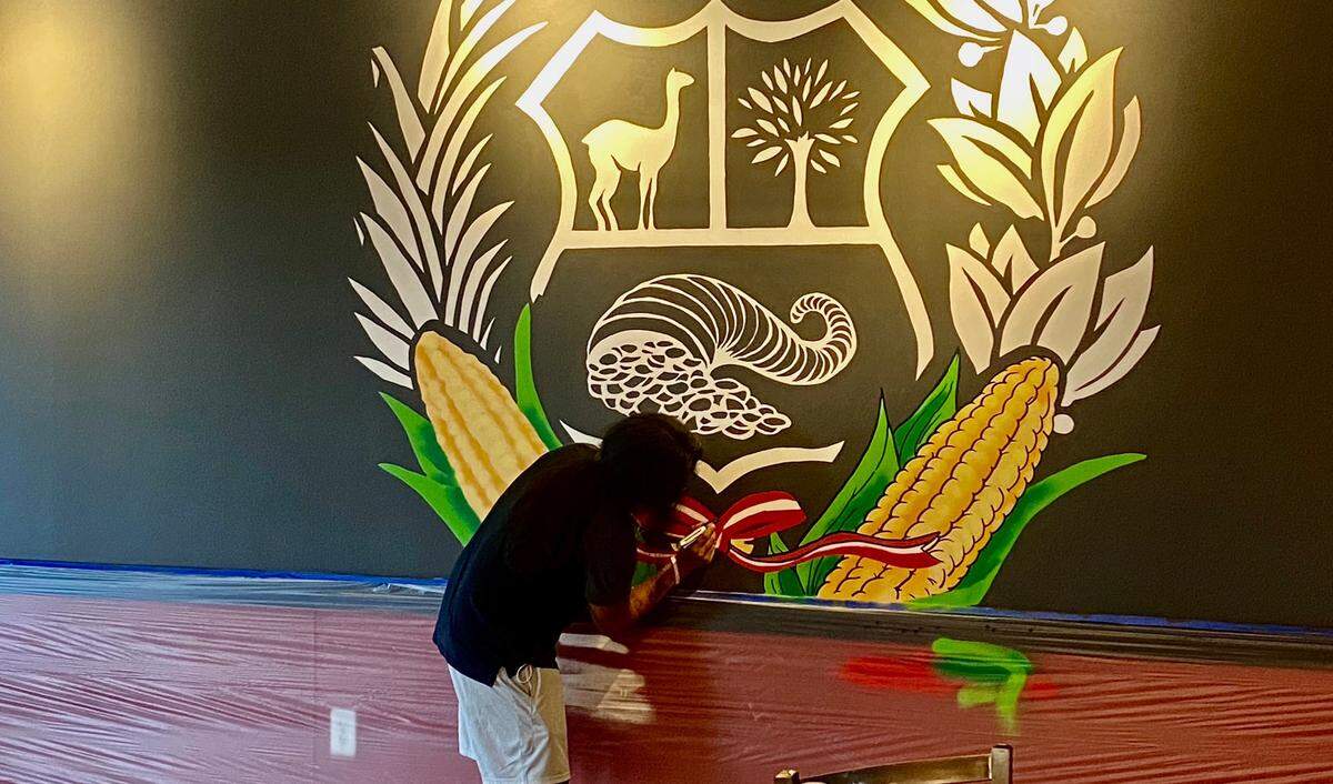 Charlotte artist Juan Tresierra, who was born and raised in Trujilo, Peru, works on his mural inside Panca Peruvian.