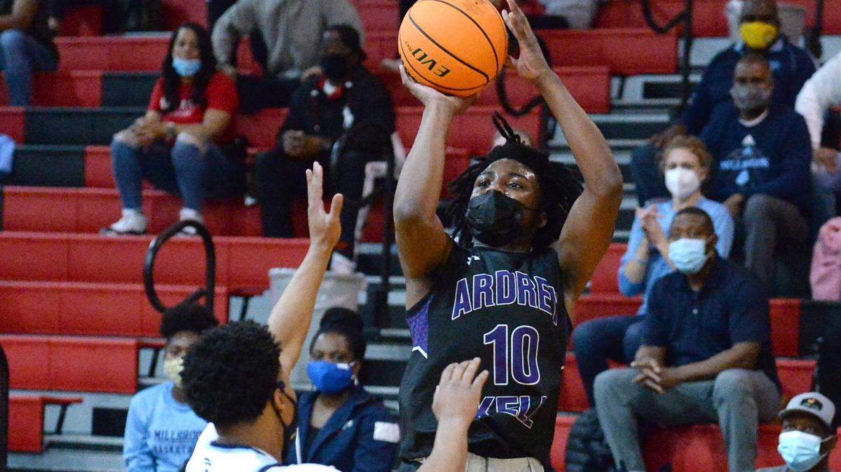 Ardrey KellÕs Knoah Carver, right, releases a shot over MillbrookÕs Jaylen Donaldson, left, during second quarter action at Wheatmore High School in Trinity, NC on Saturday, March 6, 2021.