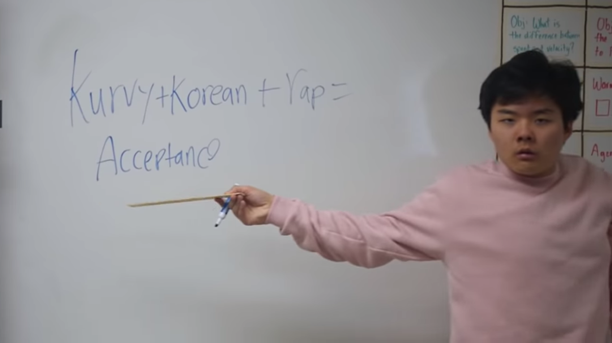 High school senior Ethan Kim stands in front of a white board that reads "Kurvy + Korean + Rap = Acceptance" during a nearly 4-minute long music video angling to get him accepted into Harvard.