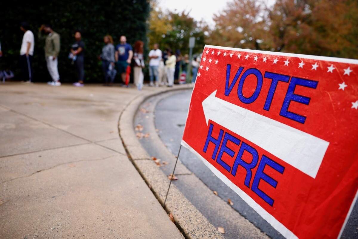 A voting sign points voters to the poll at Charlotte Mecklenburg Library at University City on Tuesday, Nov. 5, 2024.
