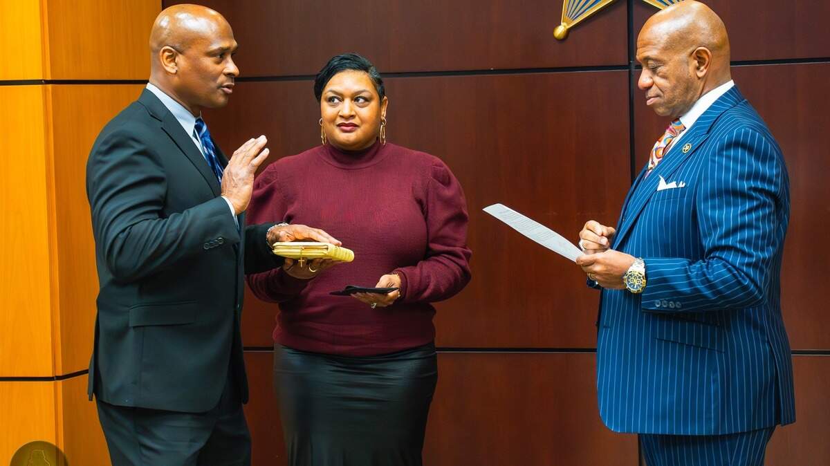 Former Chief Deputy Kevin Canty, left, is sworn in earlier this year, in February. Canty has resigned and accused Sheriff Garry McFadden, right, of abusing his power.