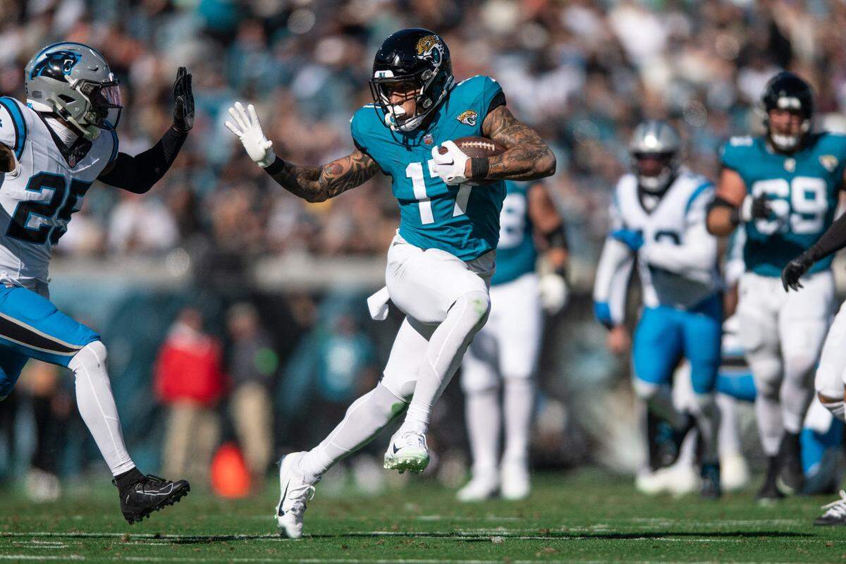 Jacksonville Jaguars tight end Evan Engram (17) runs after the catch against Carolina Panthers safety Xavier Woods (25) in the second quarter at EverBank Stadium.