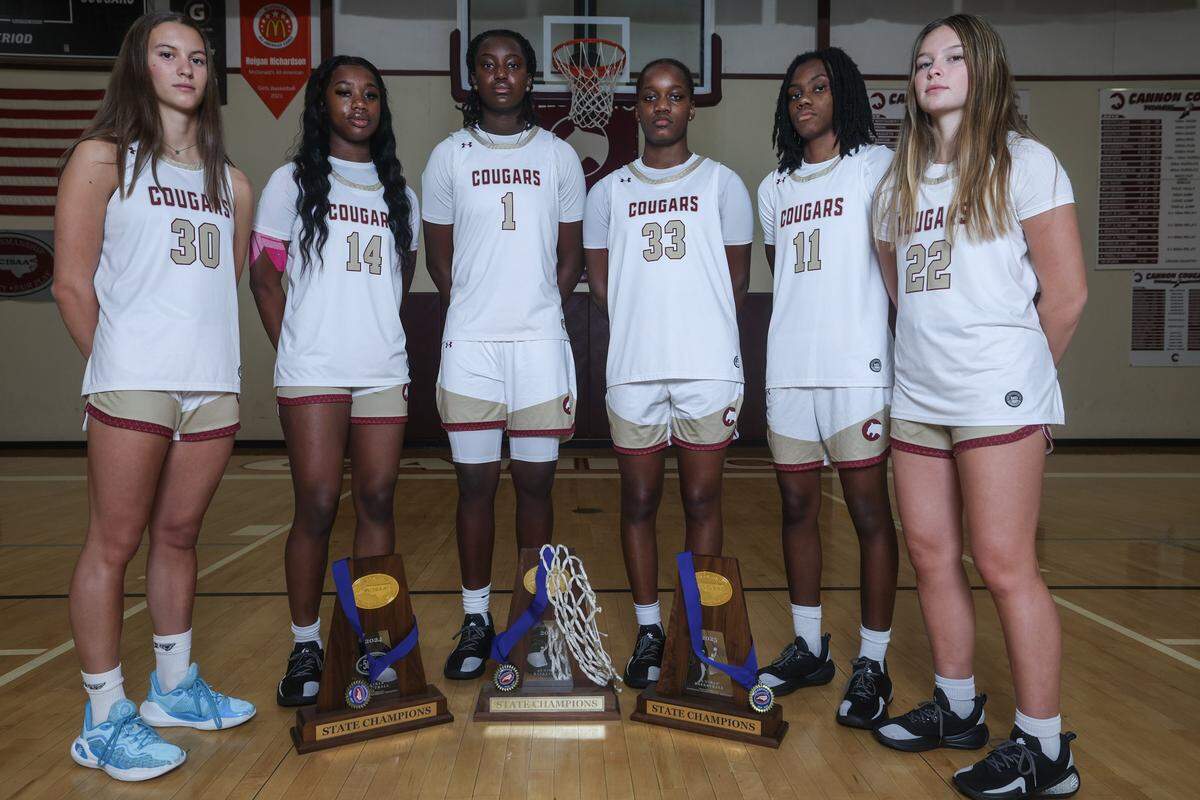 The girls basketball team at Cannon School in Concord, NC pose with their three NCISAA championship trophies on Wednesday, November 4, 2025.