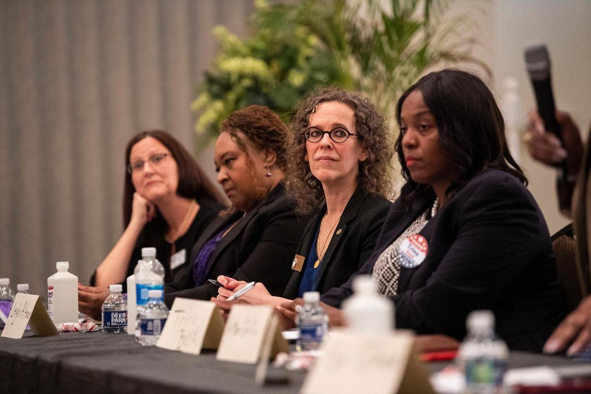 Leigh Altman, second from right, listen during the Black Political Caucus’ forum for county commissioner candidates at C N Jenkins Memorial Presbyterian Church on Thursday, March 31, 2022 in Charlotte, NC.