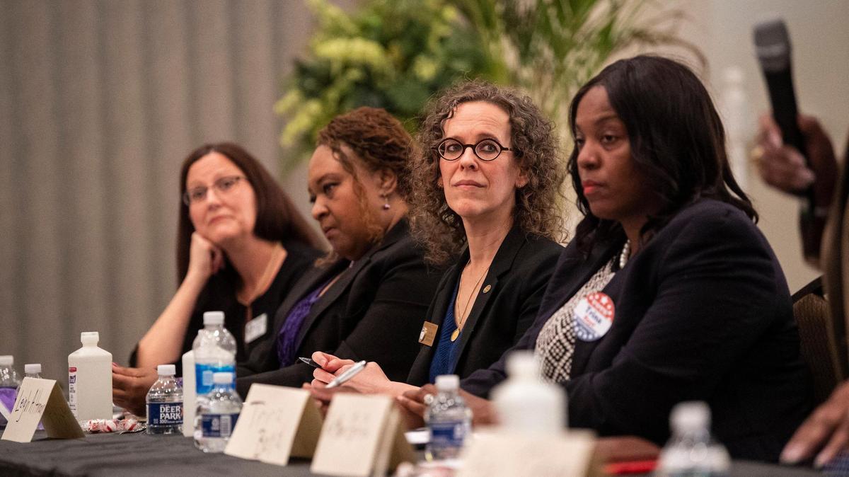 Leigh Altman, second from right, listen during the Black Political Caucus’ forum for county commissioner candidates at C N Jenkins Memorial Presbyterian Church on Thursday, March 31, 2022 in Charlotte, NC.