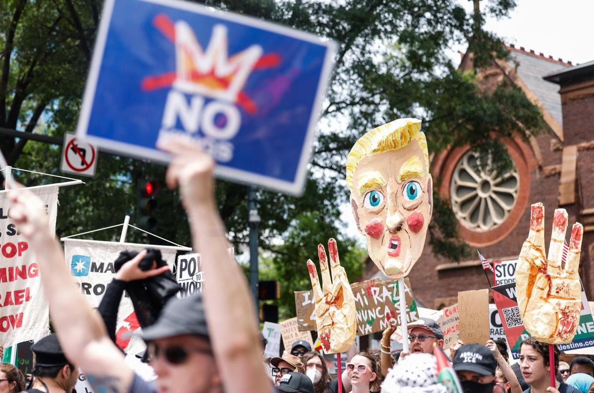Protestors walk down North Tryon and West 7th Streets during the No Kings protest in Charlotte on Saturday, June 14, 2025. Another No Kings protest will be held in Charlotte on Oct. 18.