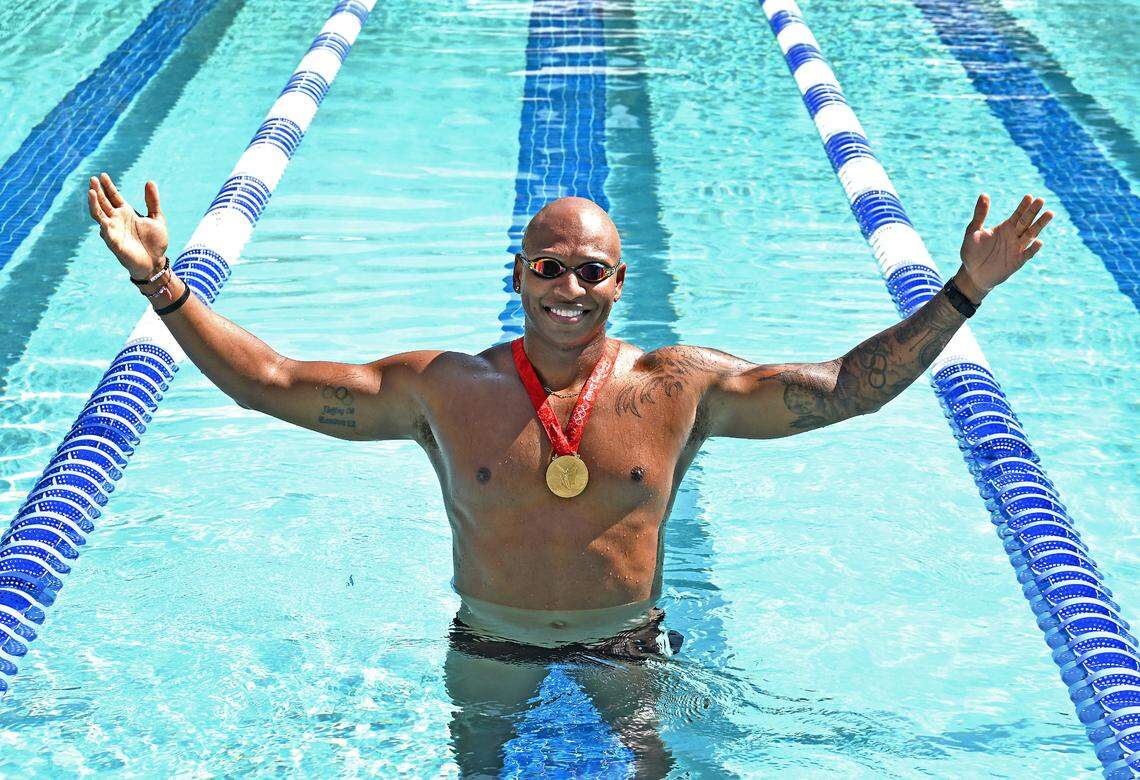 Former Olympic gold medalist swimmer Cullen Jones poses in the Life Time outdoor pool on Wednesday, June 26, 2024. Jones earned two Olympic gold and two Olympic silver medals and represented Team USA in the Olympics in 2008 and 2012.