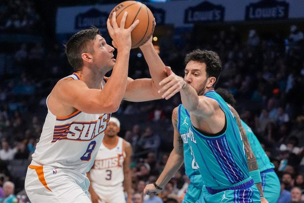 Mar 15, 2024; Charlotte, North Carolina, USA; Phoenix Suns guard Grayson Allen (8) shoots against Charlotte Hornets guard Vasa Micic (22) during the first quarter at Spectrum Center.