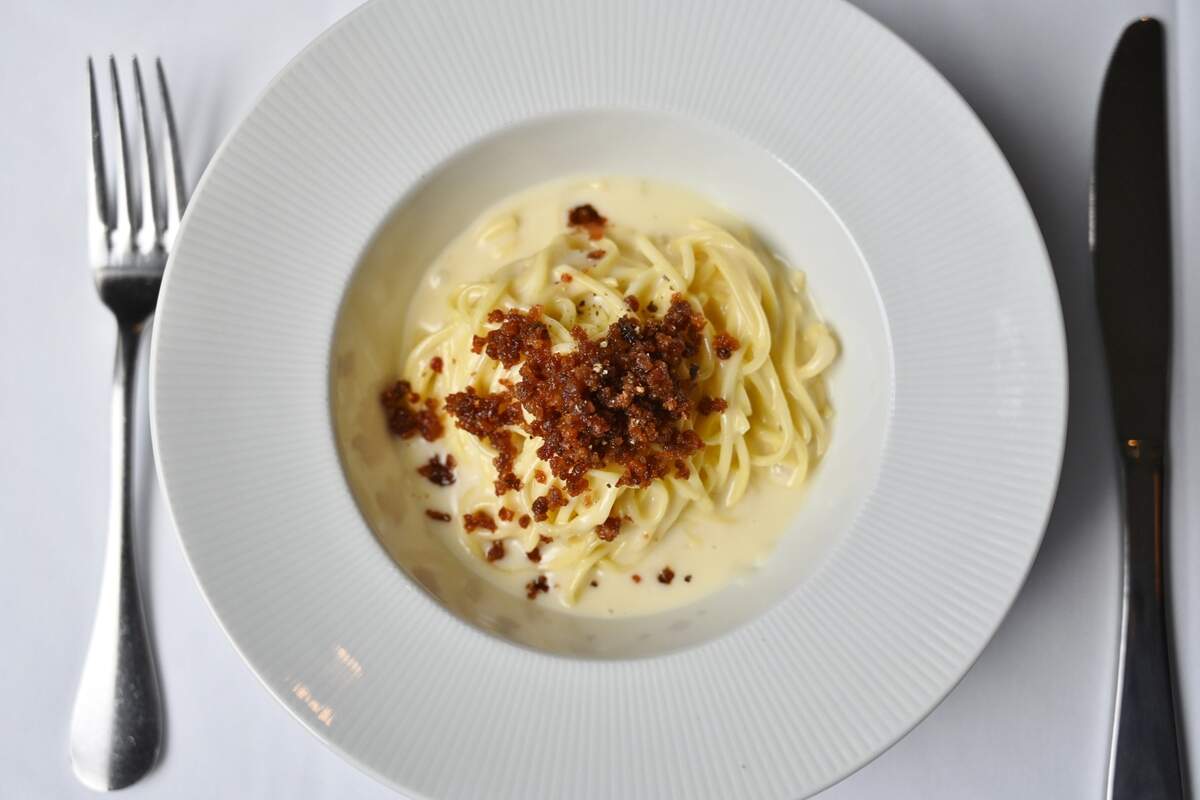 Aqua e Vino’s tajarin is fresh spaghettini bathed in Parmigiano fondue and topped with prosciutto de Parma.