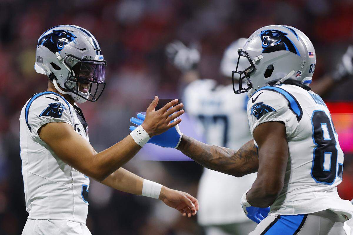 David Moore, right, celebrates with Panthers’ teammate Bryce Young after scoring a touchdown against the Atlanta Falcons.