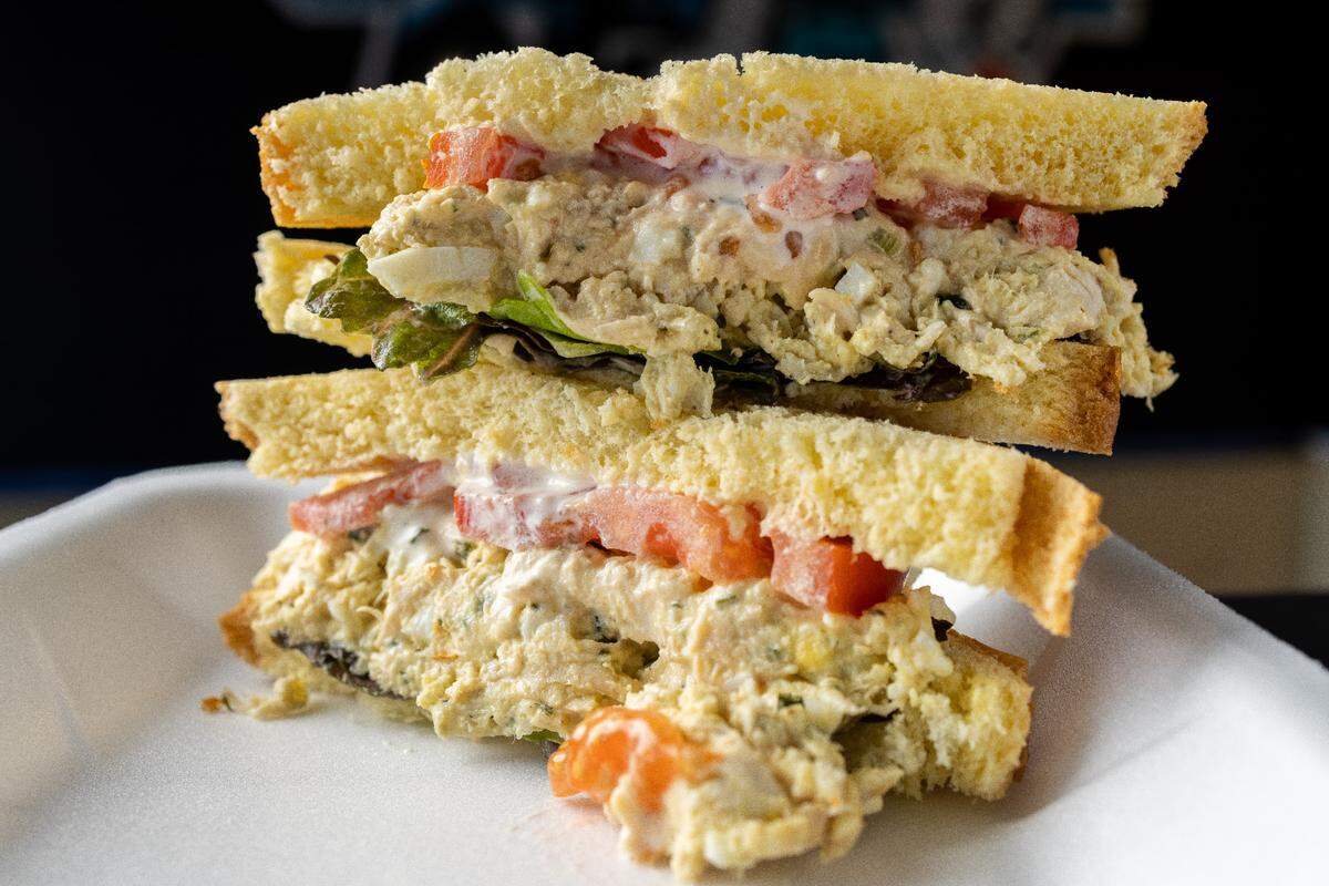 What The Fries Chicken Salad: House recipe chicken salad served with lettuce and tomato on potato bread.
