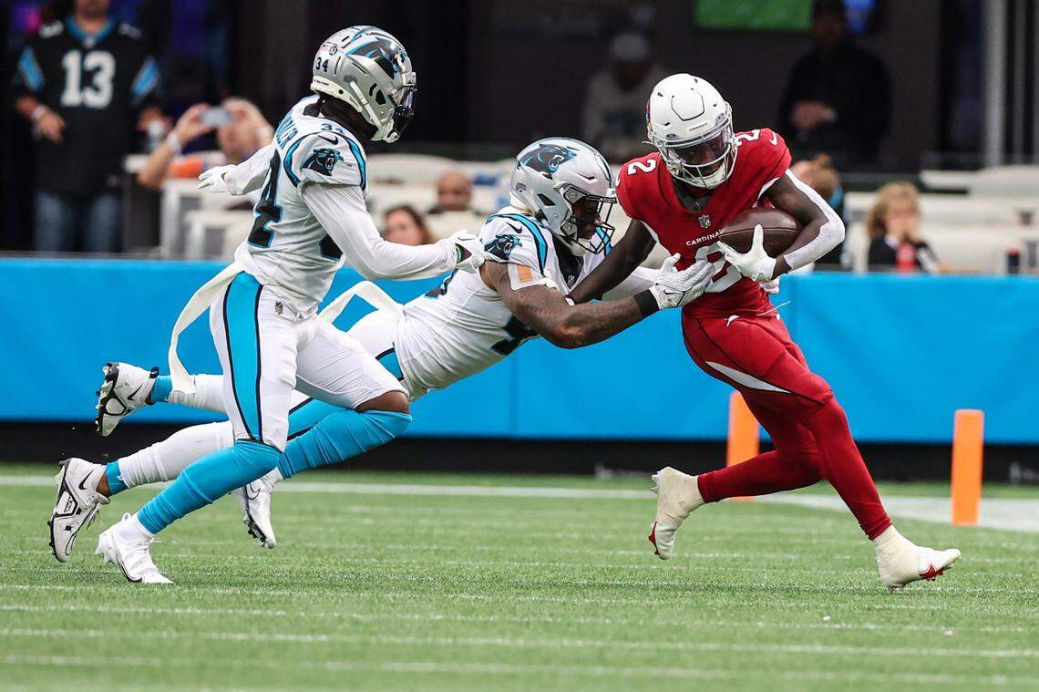 Panthers linebacker Frankie Luvu, center, grabs onto Cardinals wide receiver Marquise Brown during the game at Bank of America Stadium on Sunday, October 2, 2022, 2022 in Charlotte, NC.