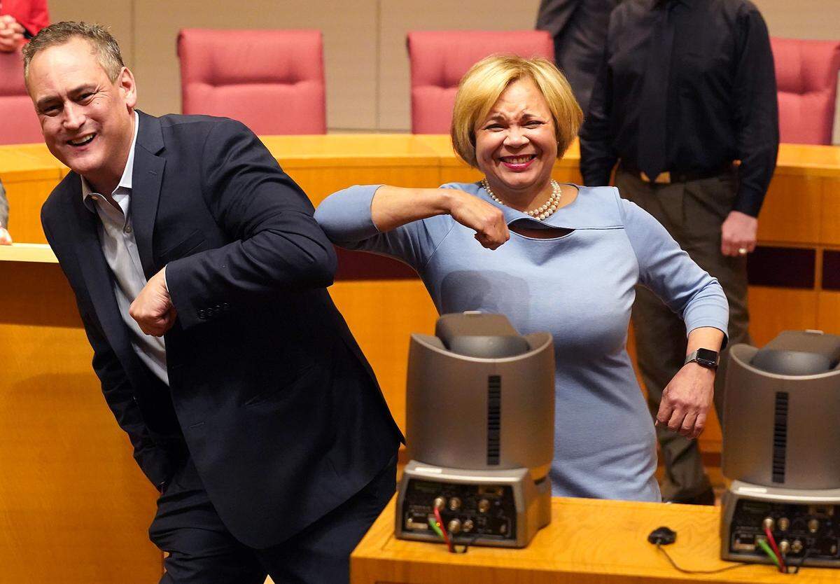 Doug Lebda, founder and CEO of LendingTree, left, bumps elbows with Charlotte Mayor Vi Lyles, right, following an announcement that LendingTree, a Charlotte-based company is donating $1 million to a community-wide fund to assist those affected by the COVID-19 crisis.                                