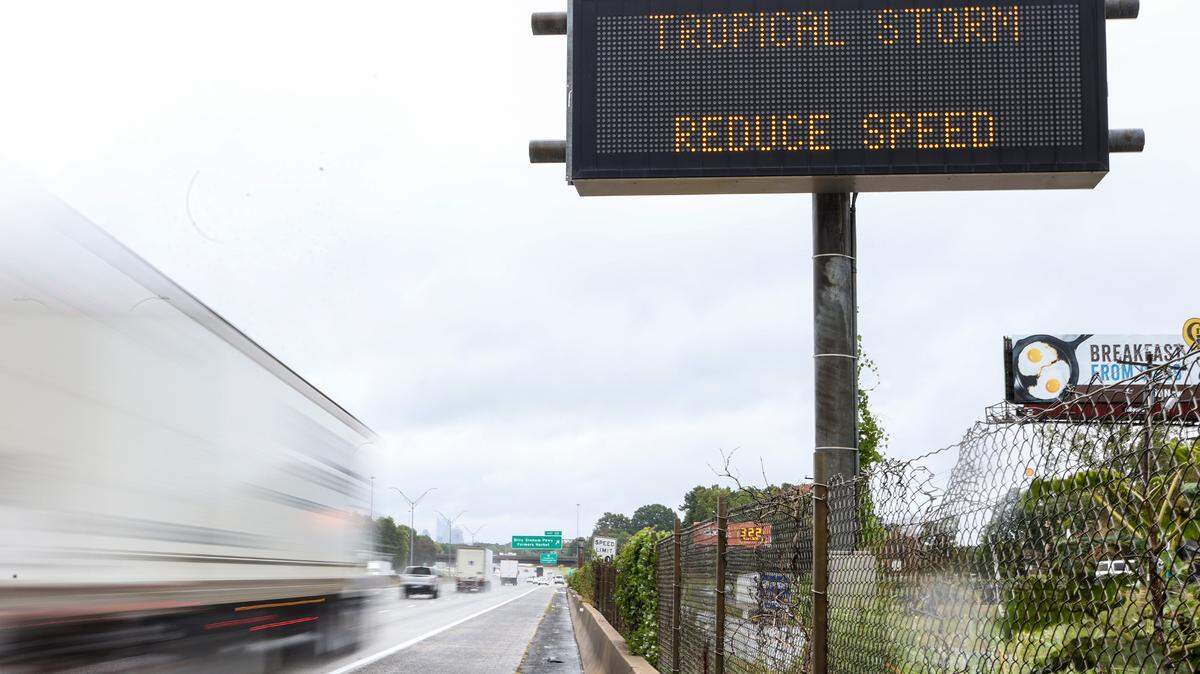 A sign along I-85 northbound cautions drivers to slow down due to inclement weather as a result of Hurricane Ian on Friday, September 30, 2022 in Charlotte, NC. About 12,000 Duke Energy customers in Charlotte were without power on Saturday morning, Oct. 1, 2022, due to the storm.