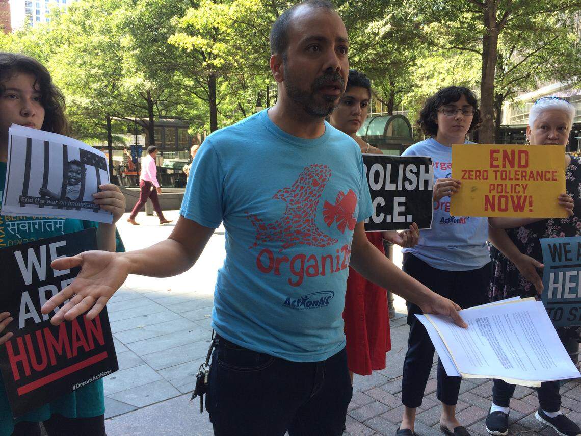 Héctor Vaca, of Action NC, speaks in front of other protesters outside of Bank of America’s Charlotte headquarters in July. The protesters gathered to criticize Bank of America and Wells Fargo for doing business with two large private prison companies that house illegal immigrants.