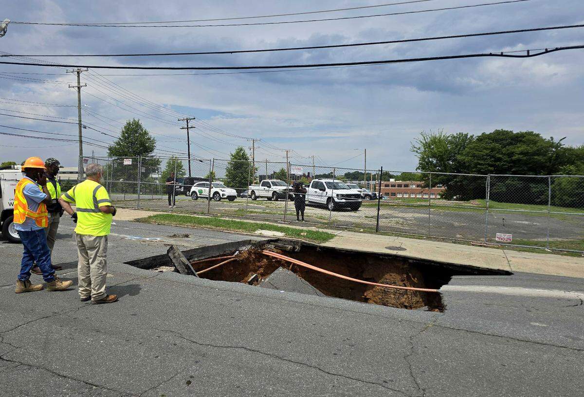 A massive sinkhole is seen on South Cedar Street near West Morehead Street in Charlotte on Tuesday, July 30, 2024. City leaders said a water leak is believed to be the cause.