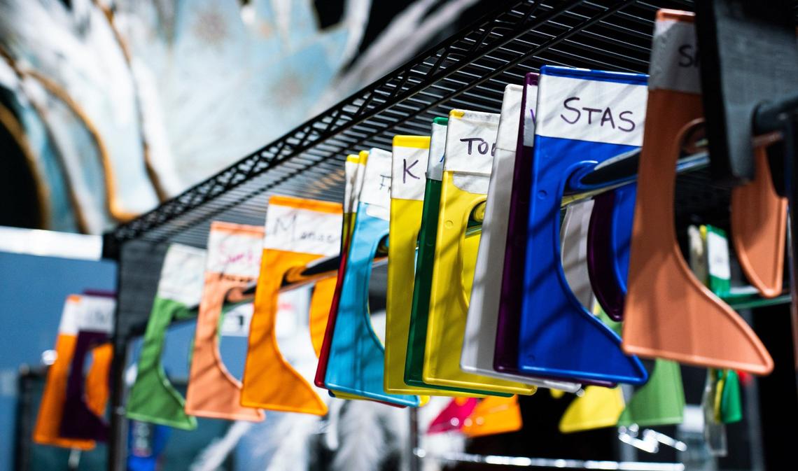 The costume hangers are labeled to prevent confusion among artists and performers during quick costume changes at Cirque Du Soleil’s CORTEO show on August 1, 2024, at the Bojangles Coliseum.