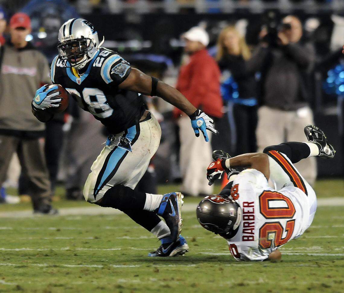 Carolina Panthers running back Jonathan Stewart (28) breaks free of Tampa Bay defensive back Ronde Barber (20) in 2008 during a Monday Night Football game on Dec. 8, 2008, at Bank of America Stadium. The Panthers won, 38-23, and ran for a franchise-record 299 yards.