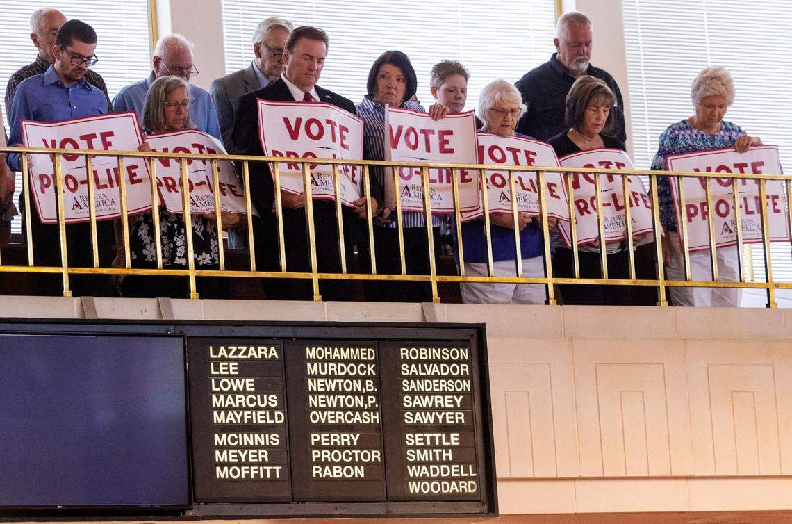 Supporters of a Senate vote to overturn Gov. Roy Cooper’s veto of an abortion restriction bill stand for an opening prayer in the Senate gallery Tuesday, May 16, 2023, at the Legislative Building in Raleigh, N.C. Senate Republicans voted to overturn the veto.