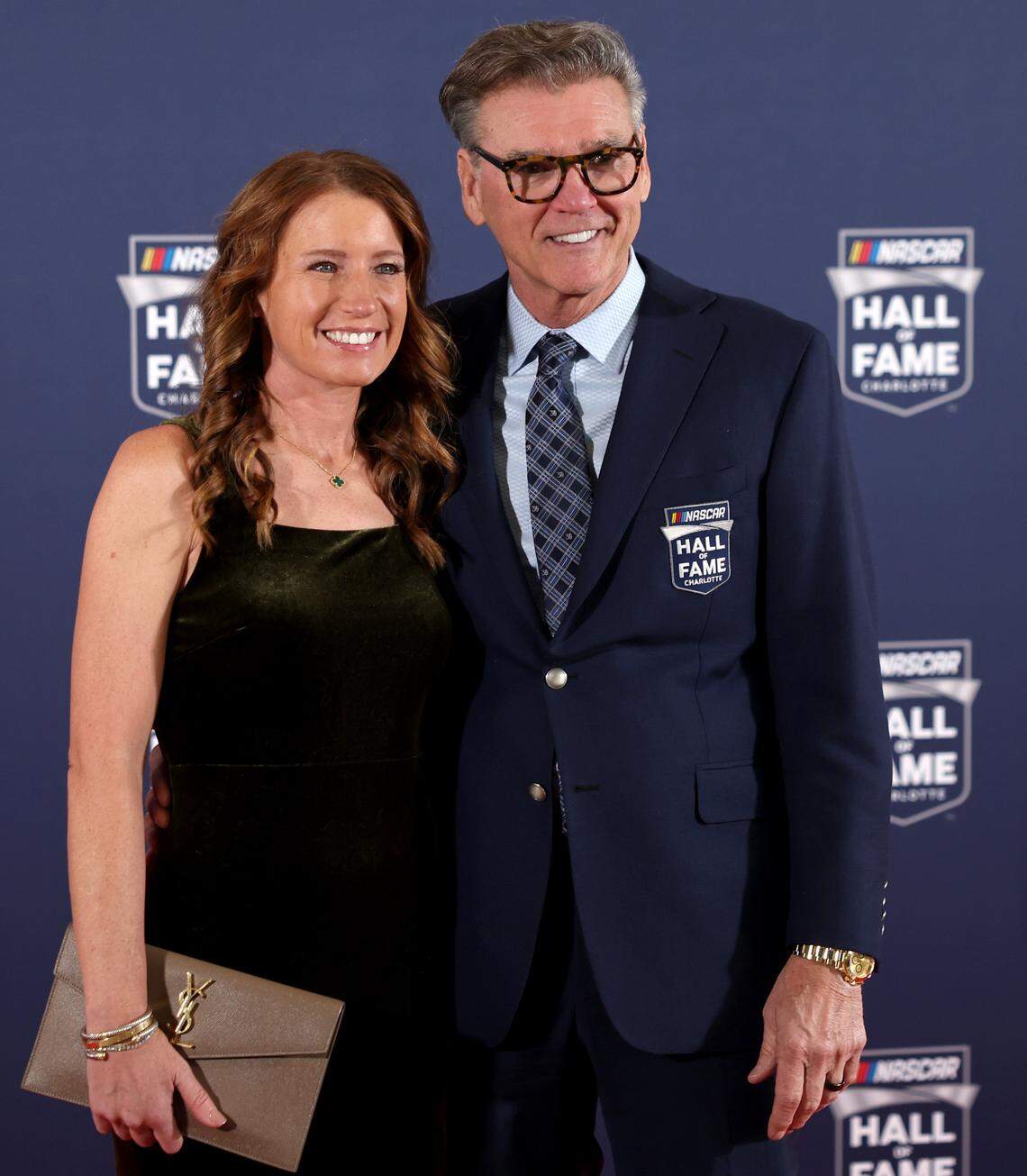 Former NASCAR crew chief Ray Evernham, right and wife, Erin Crocker, left, pose for photographs along the red carpet at the NASCAR Hall of Fame on Friday, January 23, 2026.