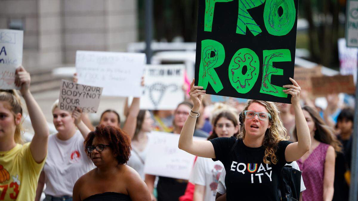 Meaghann Bernardy, of Charlotte, N.C., marches with other abortion rights activists along South Davidson Street in Charlotte, N.C., Sunday, June 26, 2022.