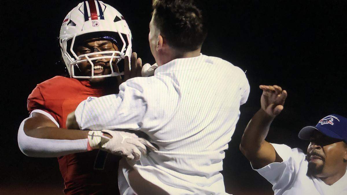A Providence Day player and coach celebrate a big play in the first half of Friday’s game with Rabun Gap