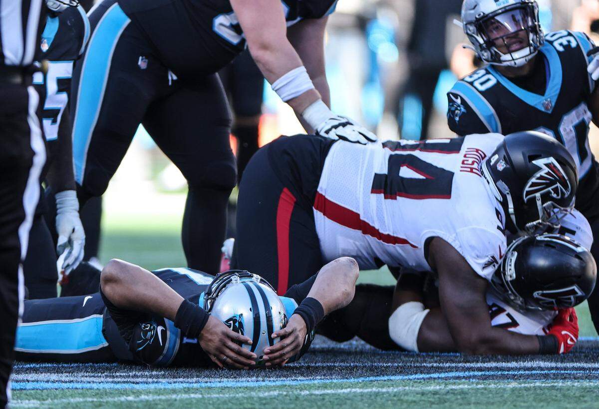 Carolina Panthers Cam Newton lays on the ground after the Atlanta Falcons recovered a fumble at the Bank of America Stadium in Charlotte, N.C., on Sunday, December 12, 2021.