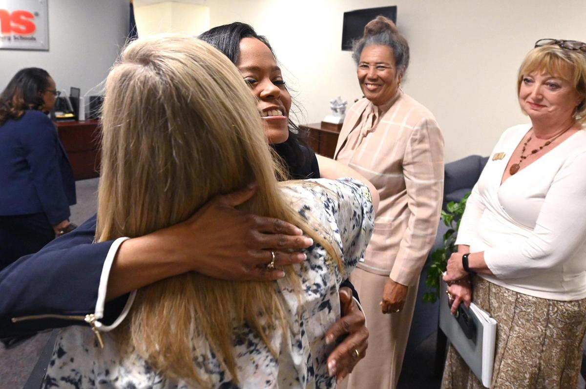 New CMS superintendent Crystal Hill hugs members of the CMS Board of Education following a 6-3 vote to name her the school districts new superintendent on Friday, May 19, 2023. Hill had been in an interim role since January. Hill will oversee the second-largest school system in North Carolina and the 17th-largest district in the country.