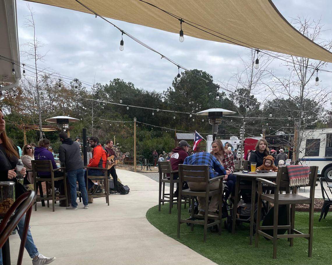 People gather at Red’s Corner in Southern Pines, N.C. on Monday, Dec. 5, 2022.