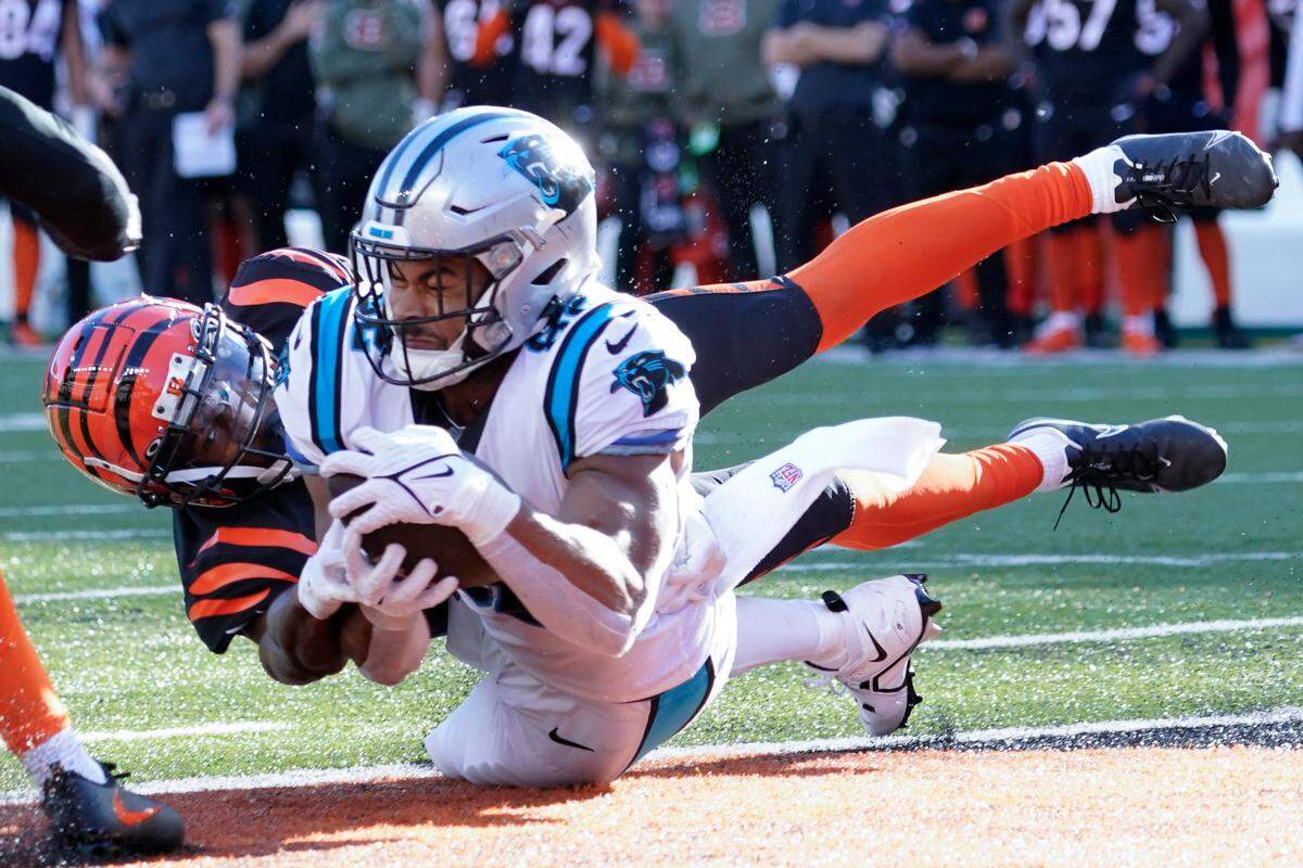 Carolina Panthers tight end Tommy Tremble (82) makes a touchdown catch as Cincinnati Bengals safety Dax Hill (23) defends during the second half of an NFL football game, Sunday, Nov. 6, 2022, in Cincinnati. (AP Photo/Joshua A. Bickel)