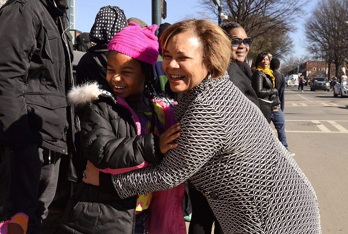 Seven-year-old Jasmine Boxley got a hug from Vi Alexander Lyles during the Martin Luther King Jr. parade Saturday. About 4,000 people are expected to attend the annual Martin Luther King Jr. parade that travels south on Tryon Street featuring marching bands, Greek, community, civic organizations,  and local community leaders on Saturday January17, 2015. 