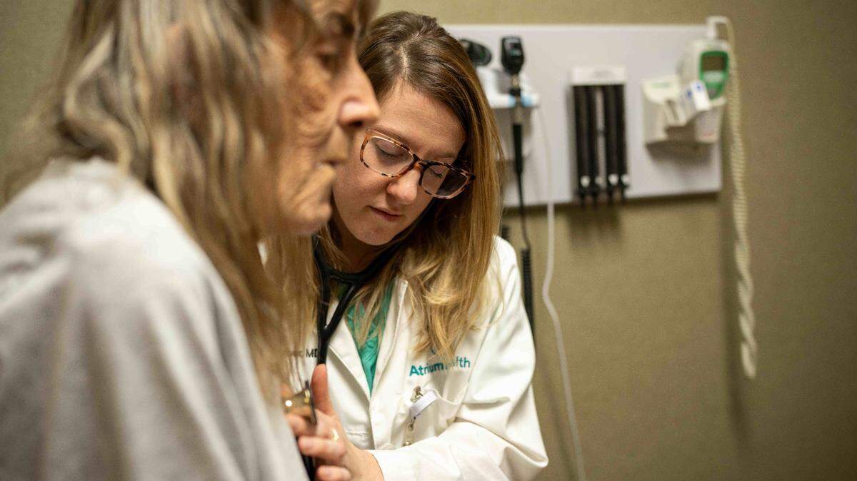 Dr. Paige Driver of Atrium Health Primary Care Cabarrus Family Medicine listens to a patient’s heart rhythm on Oct. 6, 2023, in Concord, N.C.