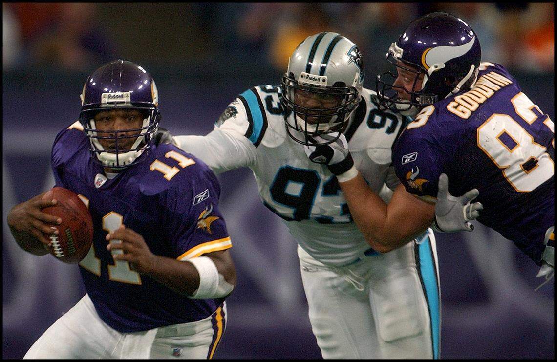 09/22/02: Minnesota Viking’s Quarterback Daunte Culpepper scramble to get free of the grasp of Carolina Panther’s Michael Rucker (93) despite the efforts of Minnesota teammate Hunter Goodwin, Sunday afternoon September 22, 2002, at the Hubert H. Humprey Metrodome.PATRICK SCHNEIDER/STAFF