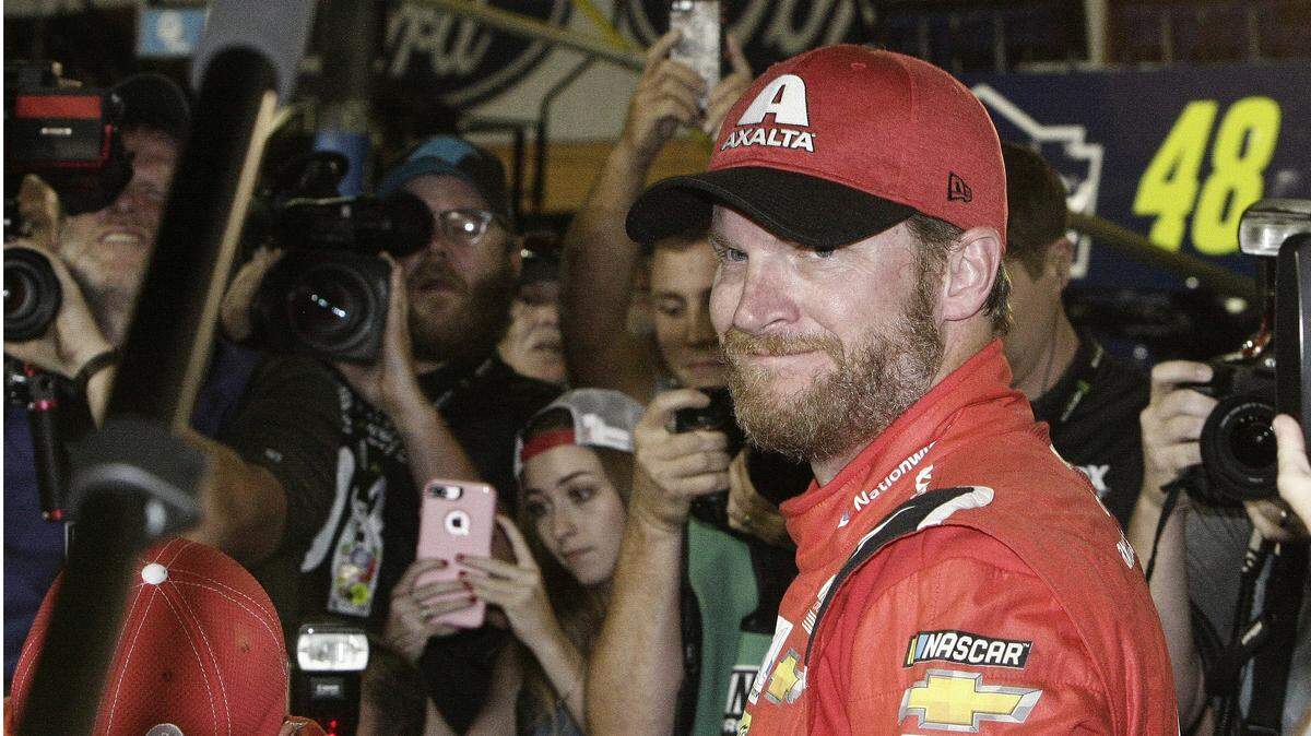 Dale Earnhardt Jr. is surrounded upon getting out of his car after a NASCAR Cup Series auto race at Homestead-Miami Speedway in Homestead, Fla., Sunday, Nov. 19, 2017. Earnhardt is retiring from full-time racing.