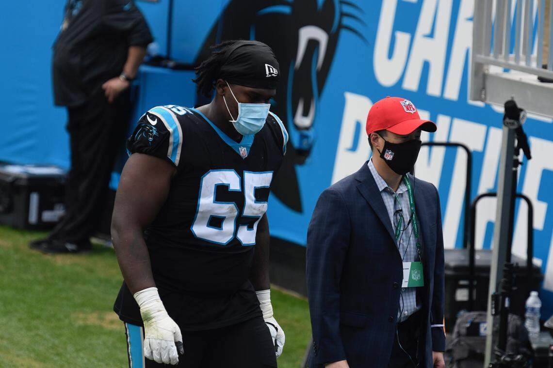 Carolina Panthers offensive guard Dennis Daley (65) is escorted to the locker room following an injury Sunday November 22, 2020.