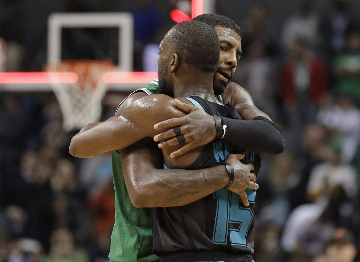 Charlotte Hornet Kemba Walker (15) and Boston Celtic Kyrie Irving embrace after a Hornets victory last season. Will Walker replace Irving as the Celtics’ point guard in free-agency?