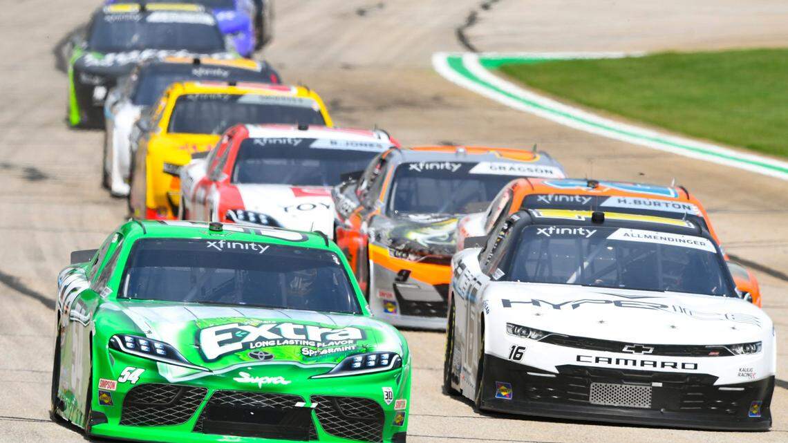 Kyle Busch, left, leads AJ Allmendinger right, as they come out of the first caution, Saturday, July 10, 2021, in Hampton, Ga. (AP Photo/John Amis)