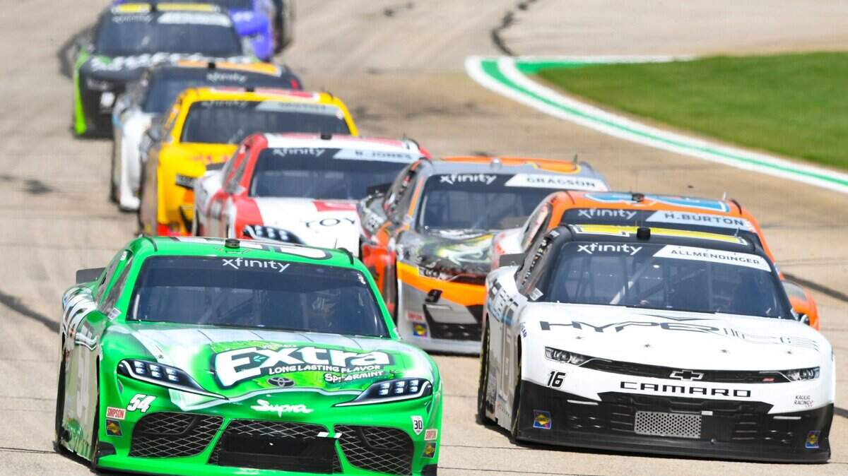 Kyle Busch, left, leads AJ Allmendinger right, as they come out of the first caution, Saturday, July 10, 2021, in Hampton, Ga. (AP Photo/John Amis)